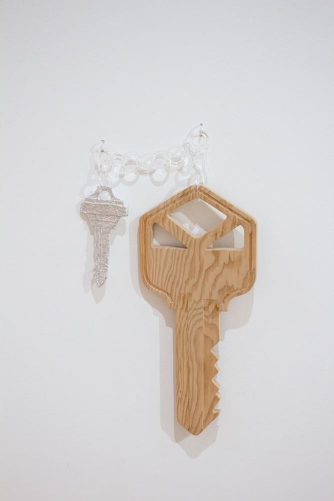 Carved wood and sculpted papier mache keys on a lucite chain