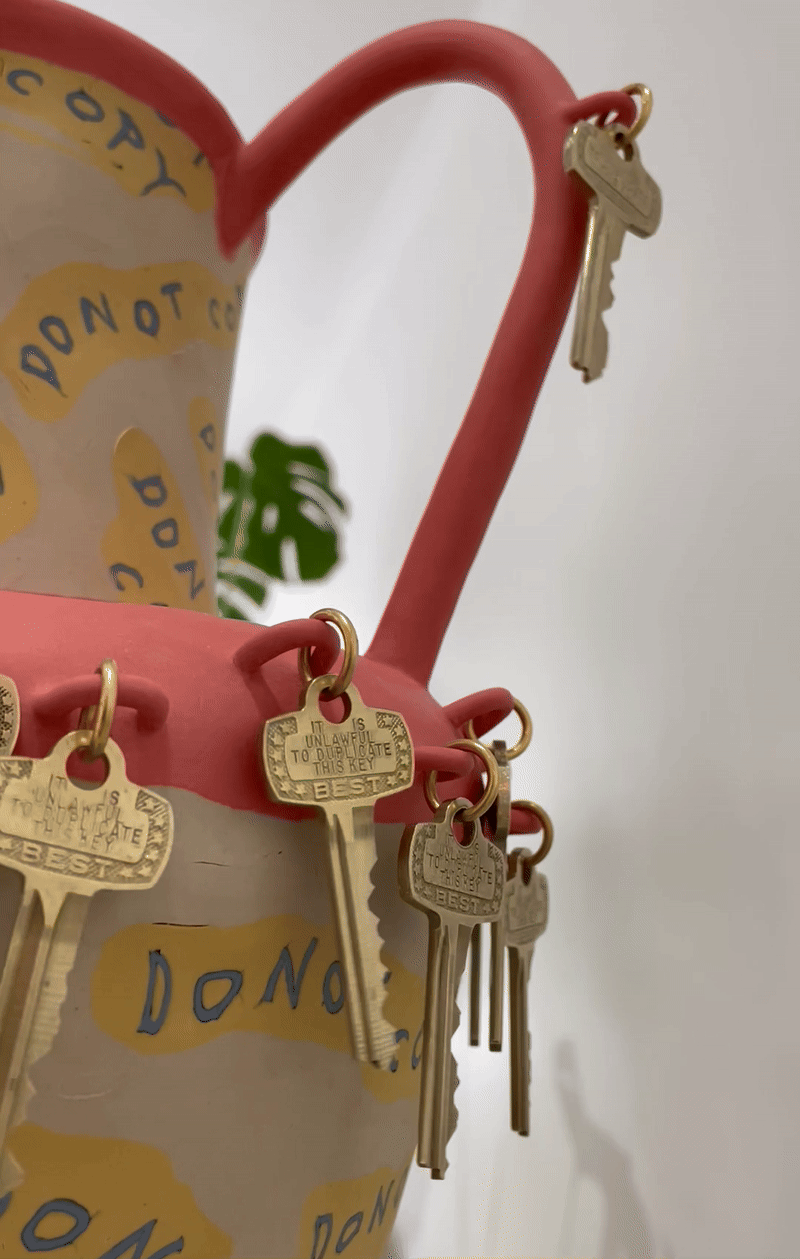 Ceramic nerikomi vase with DO NOT COPY inlaid repeatedly in coloured clay and brass keys dangling all around